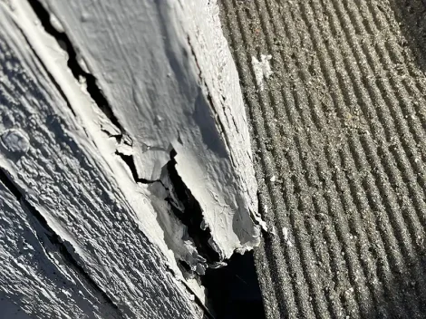 Exterior trim with peeling paint and dry rot damage